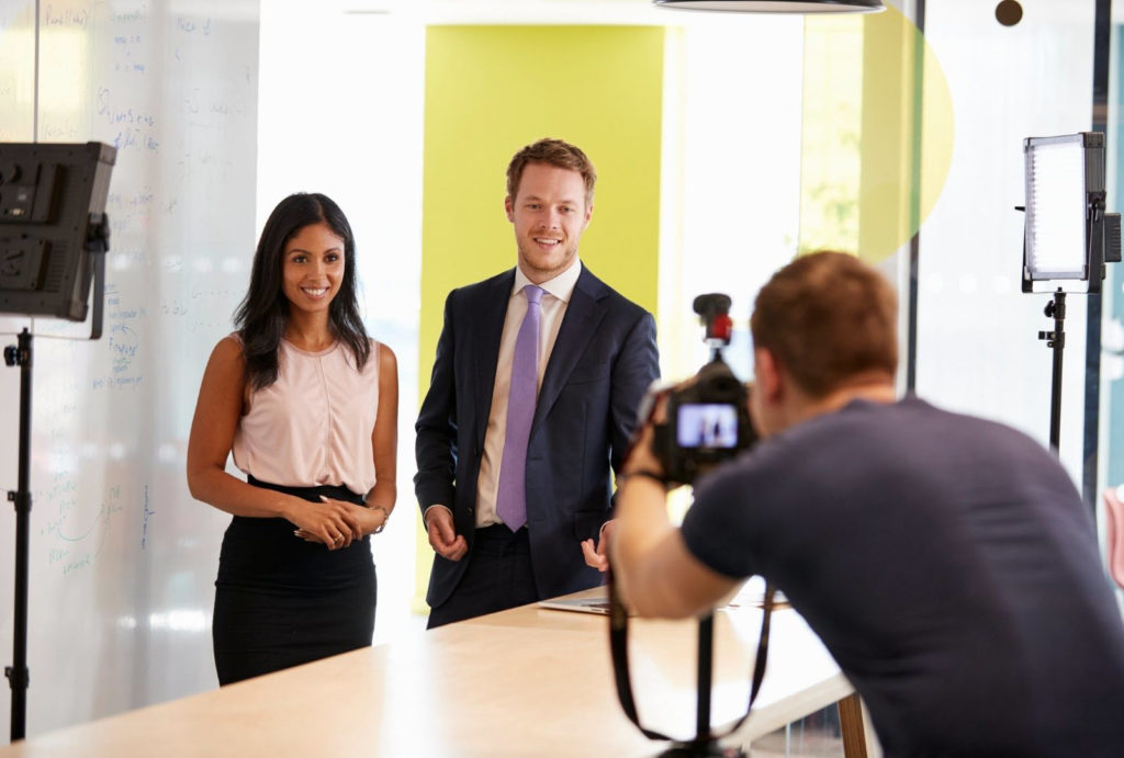Man and a woman in professional clothes being filmed for a corporate video in Brisbane